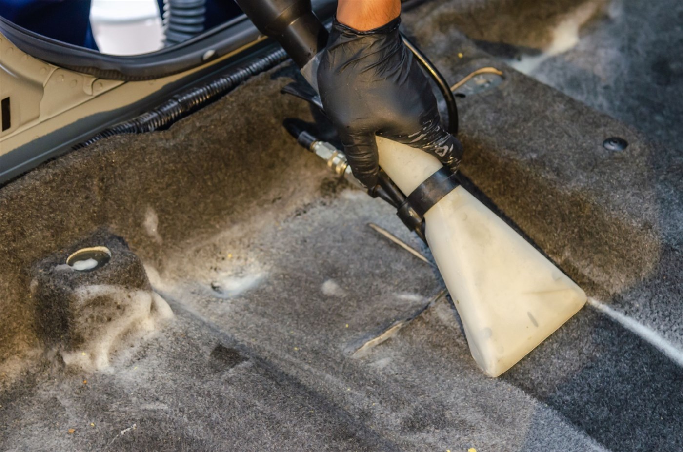An extraction tool cleaning upholstery fabric