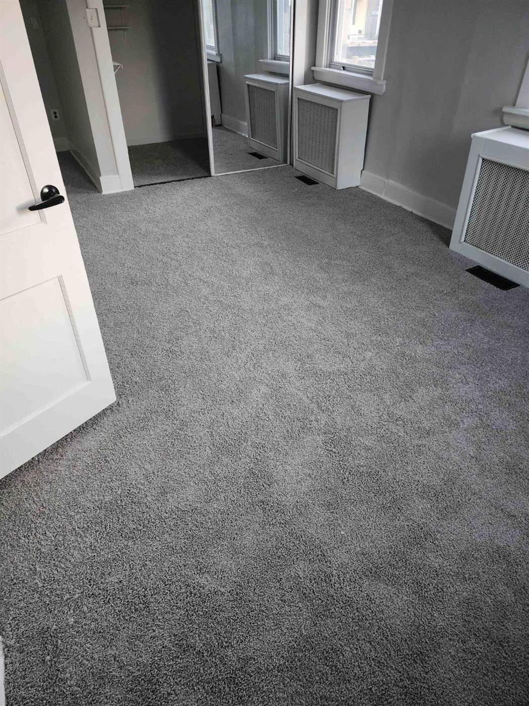 A bedroom with newly installed carpet